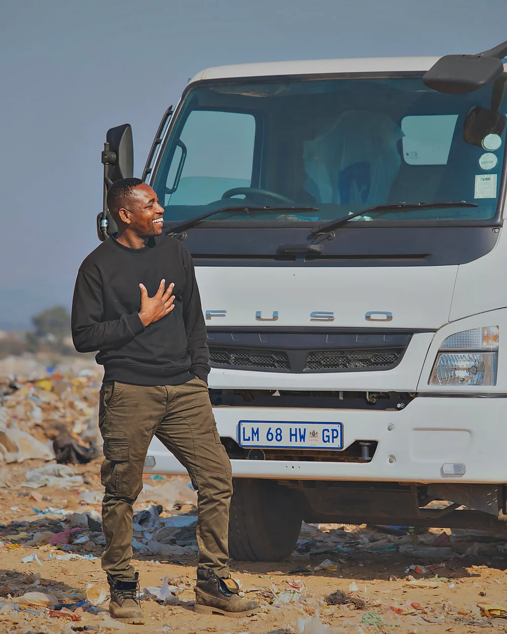 A Murero crew member alongside the hook-lift truck on a collection round.